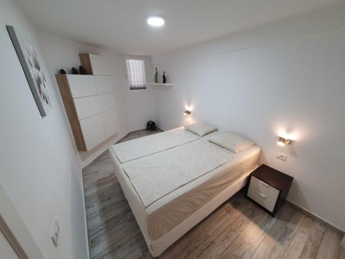 a bedroom with a bed in a white room at Lookout Point Tenerife Holiday Apartment Las Americas in Playa Fañabe