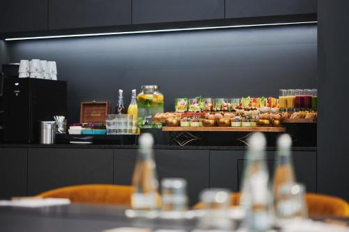 a buffet line with pastries and drinks on display at Stay inn Hotel Warszawa in Warsaw