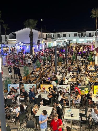 a large group of people sitting at tables at night at B&B Villa Anna in Sibari
