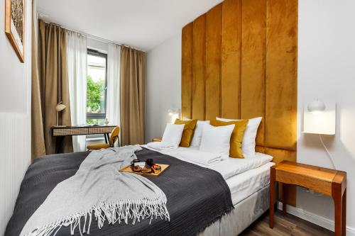 um quarto de hotel com uma cama grande com uma bandeja em Scala Apartments by HappyStay em Gdansk