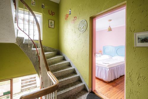 a room with a staircase and a bedroom with a bed at Tiglkåk in Åndalsnes