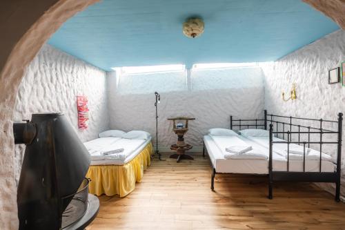 a room with two beds and a flat screen tv at Tiglkåk in Åndalsnes