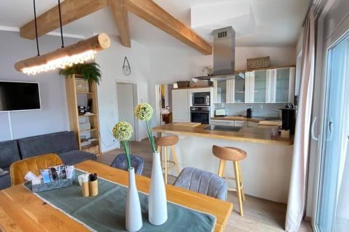 a kitchen and a living room with a table and chairs at Penthouse in Sonthofen in Sonthofen