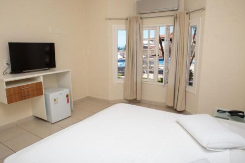 Hotel Nova Guarapariにあるベッド