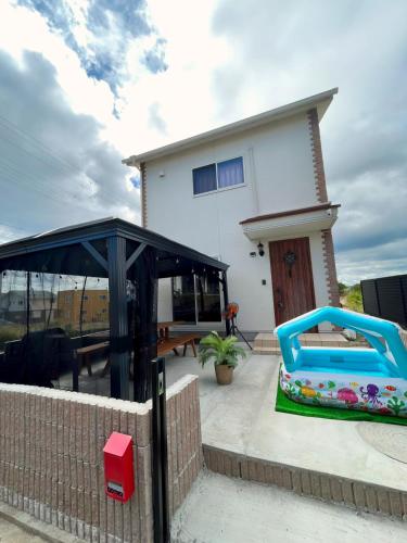 a house with a playground in front of it at 白浜リゾート・源 in Kanayama