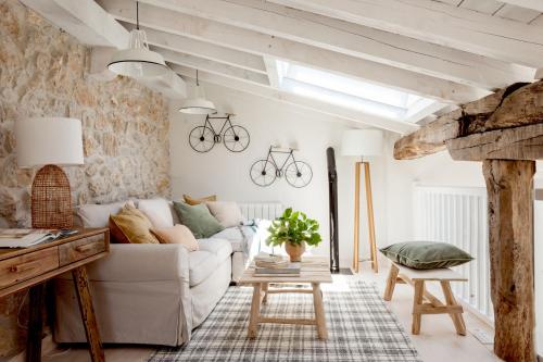 a living room with a white couch and a table at Wishome-Cuadra rehabilitada, piscina climatizada in Lamadrid