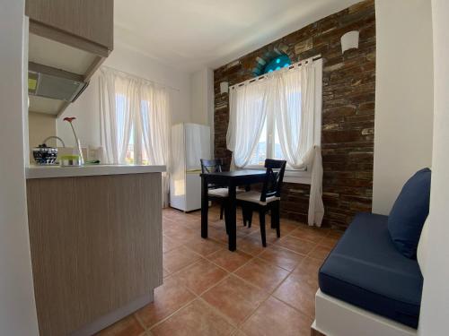 a dining room with a table and a kitchen at andros prive suites in Kipri