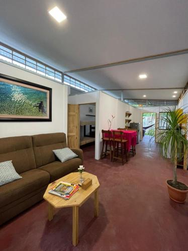 a living room with a couch and a table at Casita Coco in Puerto Limón