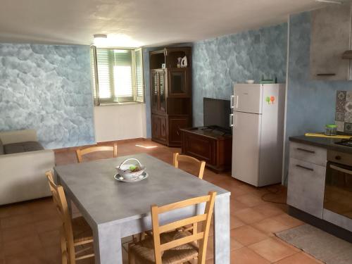 a kitchen and dining room with a table and a refrigerator at Capricornio Club Diffuso in Maiori