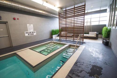 a swimming pool with a ladder in a room at Neat open concept condo Downtown Toronto in Toronto
