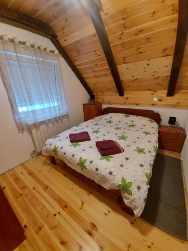 a bedroom with a bed in a wooden house at Apartmani Popovic Lux in Žabljak