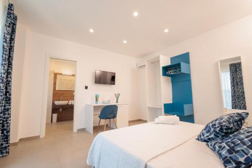 a bedroom with a bed and a desk in a room at Orizzonte Mare Panoramic Rooms in Agropoli