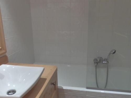 a bathroom with a shower and a sink and a tub at Appartement Méribel, 2 pièces, 5 personnes - FR-1-411-613 in Les Allues