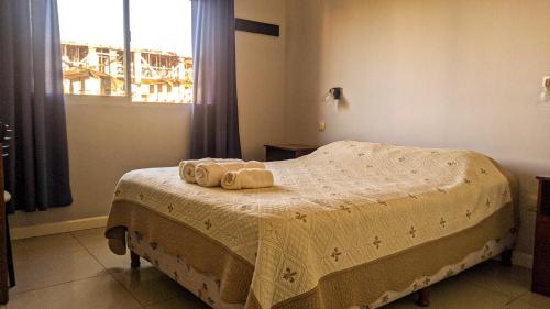 a bedroom with a bed with two towels on it at BELGRANO 124 - CORRIENTES in Corrientes