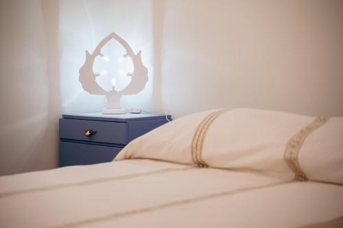 a bedroom with a bed with a dresser and a mirror at N'incanto in Rutigliano