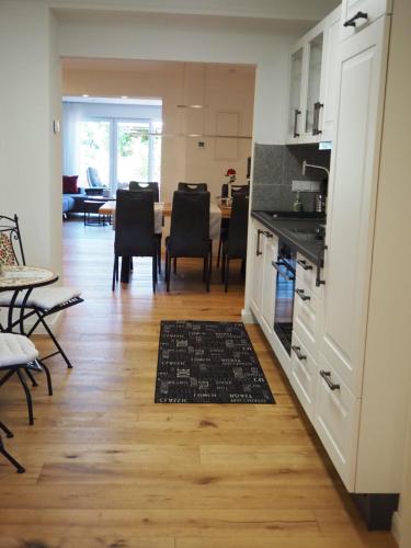 a kitchen and dining room with a table and chairs at foxxbau - urlaubswohnen im Saarschleifenland in Merzig