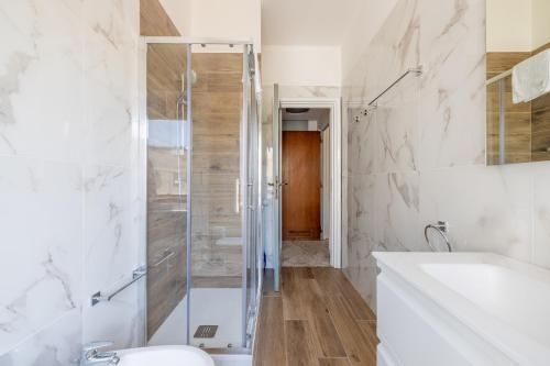 a bathroom with a shower and a toilet and a sink at White Suite in Rome in Rome