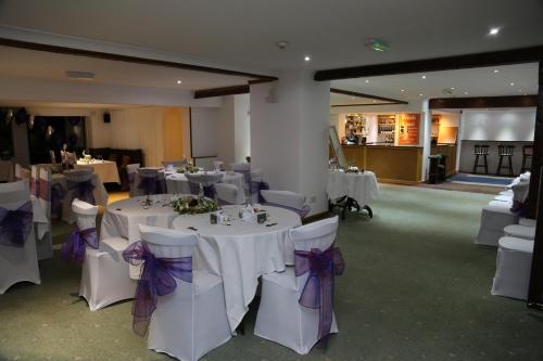 a banquet hall with white tables and purple bows at One Bedroom Apartment with Balcony at Colliford Tavern & Holiday Site in Bodmin