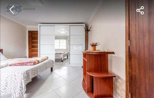 a bedroom with a bed and a sliding glass door at Krohberger Residence Hostel in Pomerode