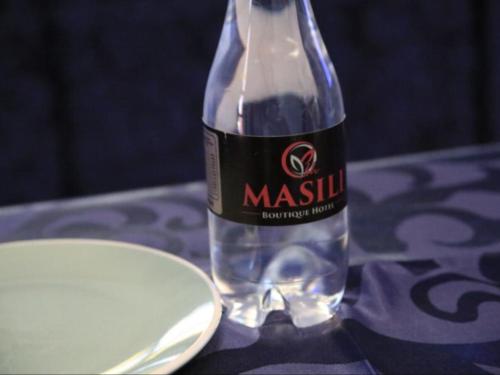 a bottle of water sitting on top of a table at Masili Boutique Hotel in Louis Trichardt