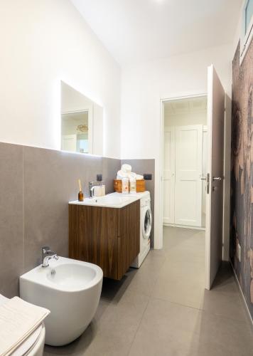 a bathroom with a sink and a washing machine at Casa al Mare 10 in Fano