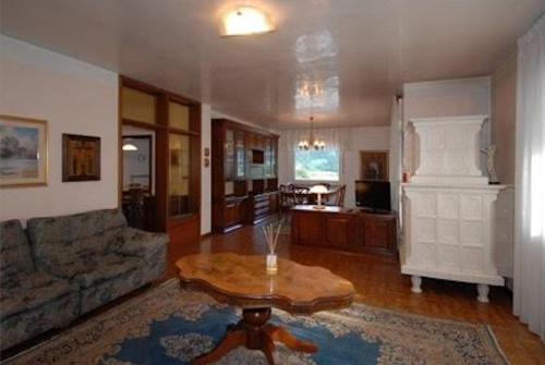 a living room with a table and a couch at Big Apartment in Predazzo