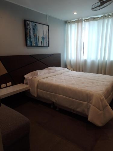 a bedroom with a large bed and a window at Hotel Continental in Barranca