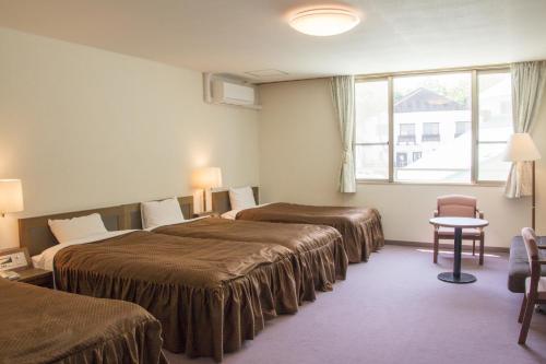 Postel nebo postele na pokoji v ubytování Hotel Oak Forest