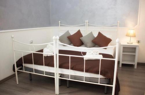 a white bed with pillows on it in a room at I Benvenuti al Sud in Naples