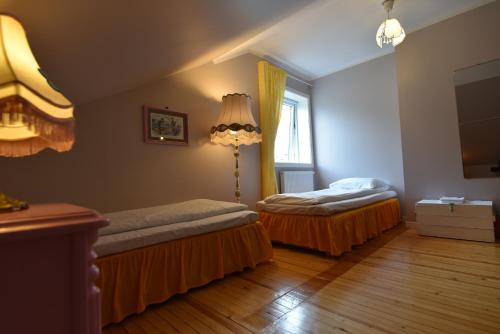 a bedroom with two beds and a lamp in it at Tiglkåk in Åndalsnes