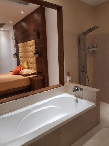 a bath tub in a bathroom with a bedroom at Luxury Beach Apartment in Hambantota