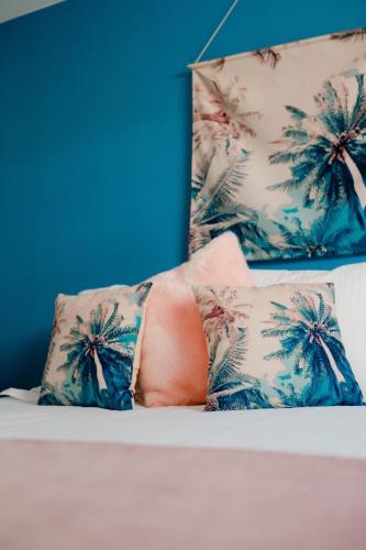 a person laying on top of a bed with two pillows at Logis Le P'tit Rouillon au Rythme de la Meuse in Annevoie-Rouillon