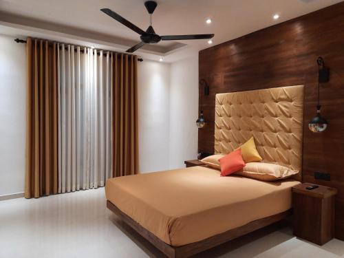 a bedroom with a bed and a ceiling fan at Luxury Beach Apartment in Hambantota
