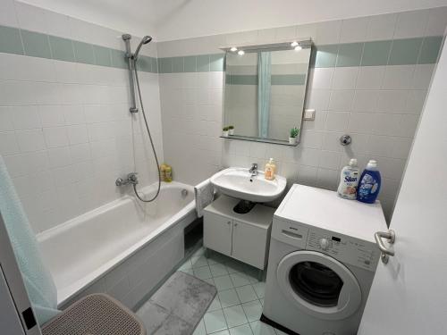 a bathroom with a washing machine and a sink at Cool Schönbrunn Apt 2BR in Vienna