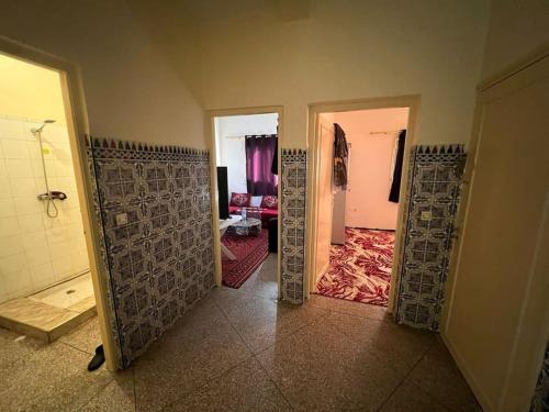 a hallway with doors open to a living room at شقة للكراء اليومي و الشهري in Agadir