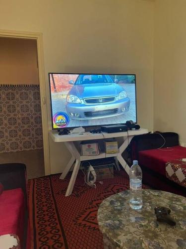 a living room with a television with a car on it at شقة للكراء اليومي و الشهري in Agadir