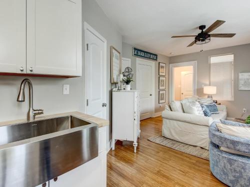 a kitchen with a sink and a living room with a couch at 7 Seas Unit 4 in Tybee Island