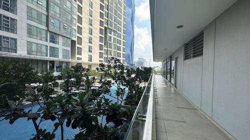 a walkway in a building with trees and buildings at Panoramic KL View @Robertson Bukit Bintang 40f in Kuala Lumpur