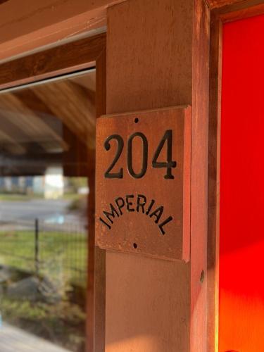 a sign on a door with the number on it at Hotel Boutique Casa&Alma in Puerto Varas