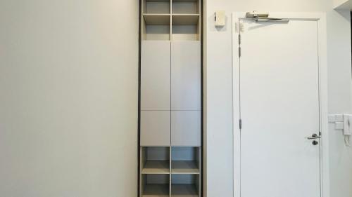 a closet with a mirror and a white door at Panoramic KL View @Robertson Bukit Bintang 40f in Kuala Lumpur