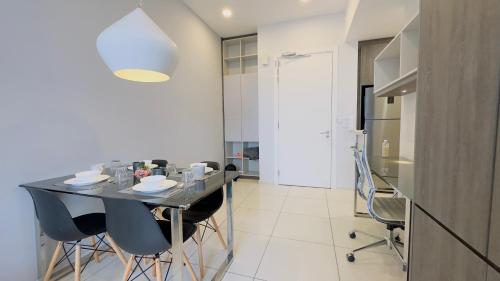 a dining room with a black table and chairs at Panoramic KL View @Robertson Bukit Bintang 40f in Kuala Lumpur