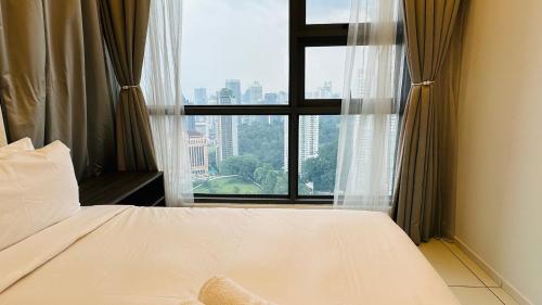 a bedroom with a bed and a large window at Panoramic KL View @Robertson Bukit Bintang 40f in Kuala Lumpur
