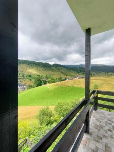 a view of a field from the balcony of a house at VILA LUCA-Hotel in Şirnea