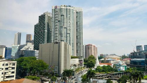 a city skyline with tall buildings and a street at Panoramic KL View @Robertson Bukit Bintang 40f in Kuala Lumpur
