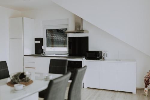 a kitchen with a table and chairs in a room at MY HOME ADDL in Štrigova