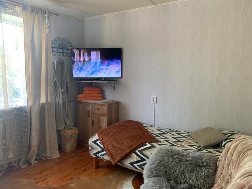a living room with a flat screen tv on a wall at Villa Mariett in Kuressaare