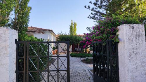 a gate to a house with flowers on it at Mediterranean house with beautiful garden in Karlovasi