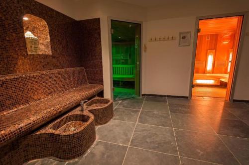 a room with a couch and two baskets on the wall at Chalet Aleblie in Susteren