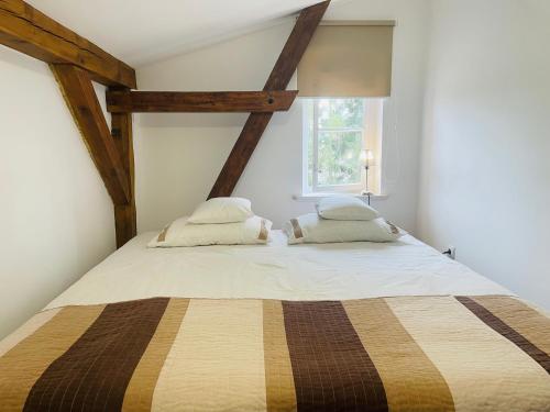 a bedroom with a large bed with two pillows at Apartamenty Cegiełka in Gąski