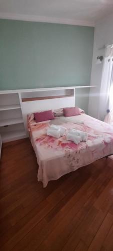 a bedroom with a bed with pink sheets and pillows at Oasi in Poggio Moiano